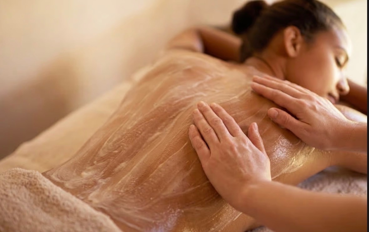 Guest receiving an Aveda body treatment at AURA Salon and Spa